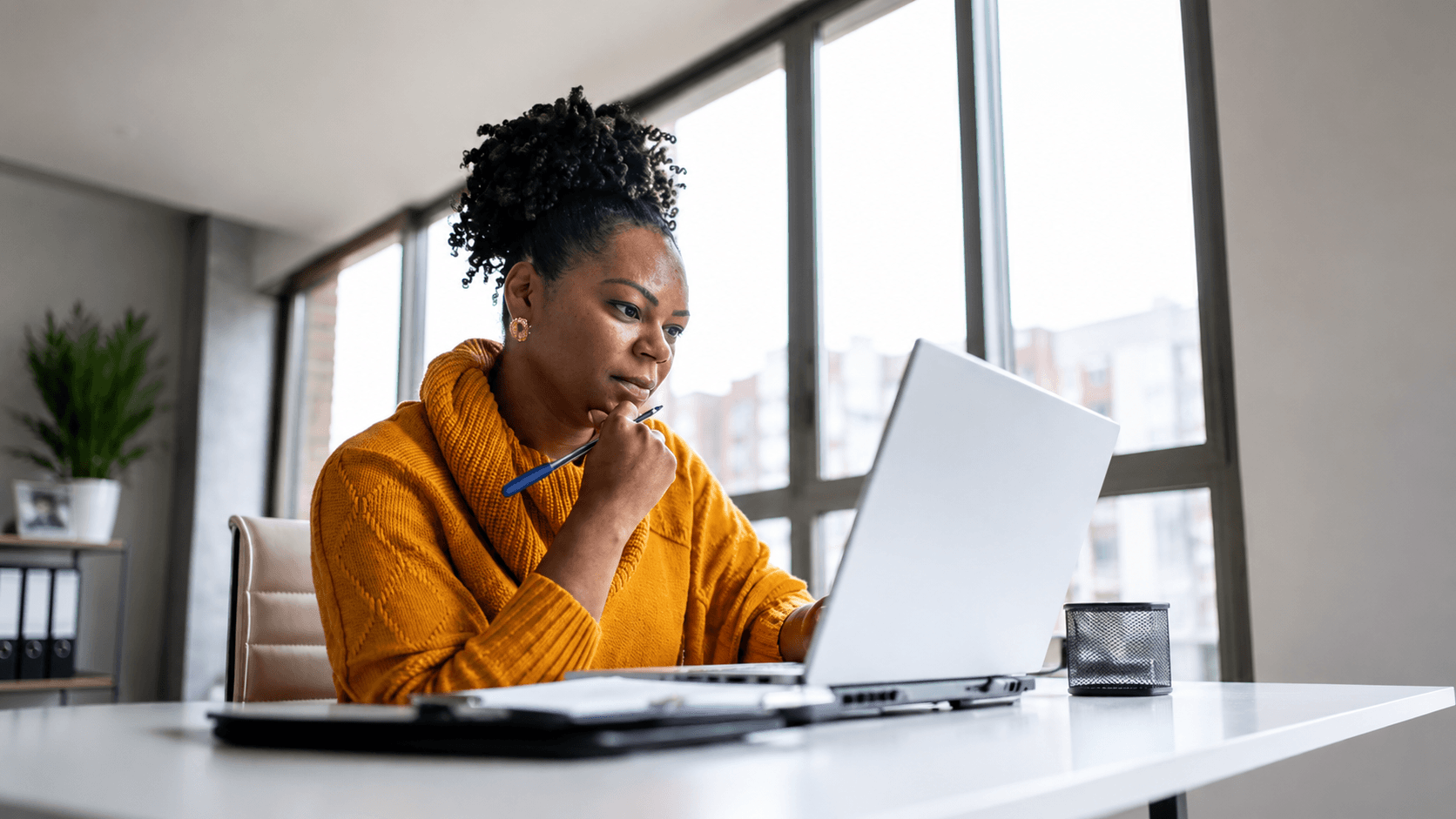Healthcare professional working on a laptop